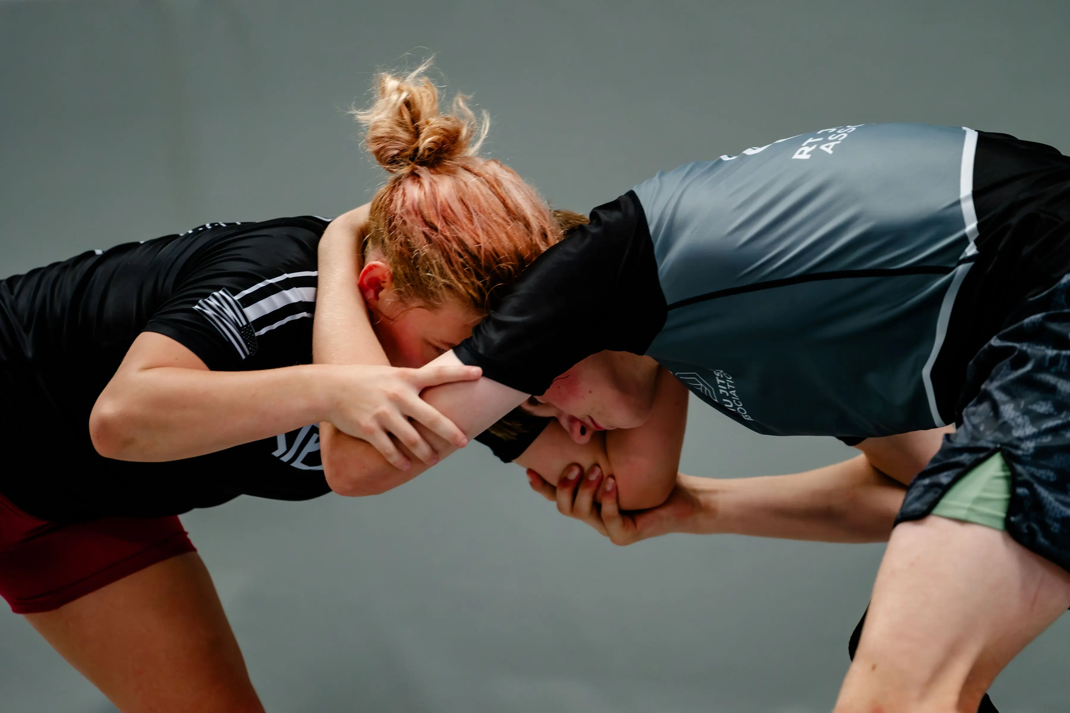 No-Gi Jiu Jitsu at RT Beachside: two training partners in rash guards locked in a clinch, fighting for grips