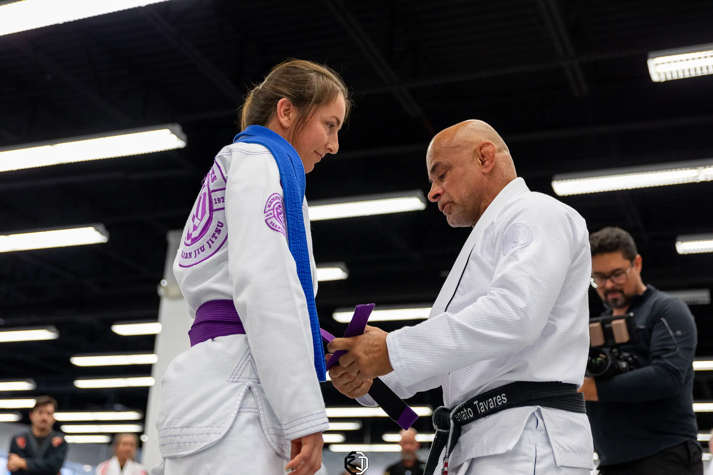 Master Renato Tavares tying a new belt on a student at RT Headquarters
