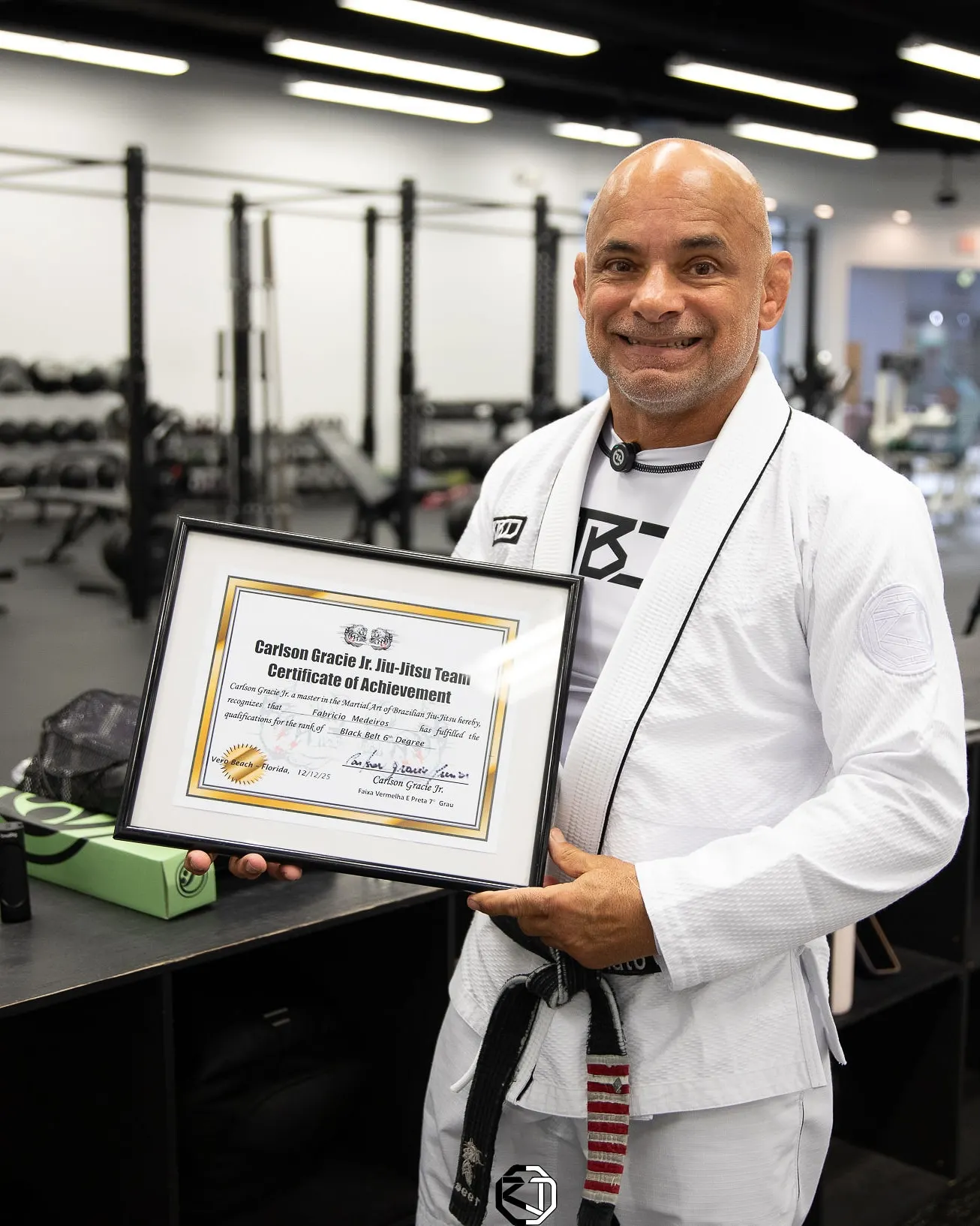 Master Renato Tavares holding his Carlson Gracie Jr. Jiu Jitsu Team certificate of achievement at RT Headquarters