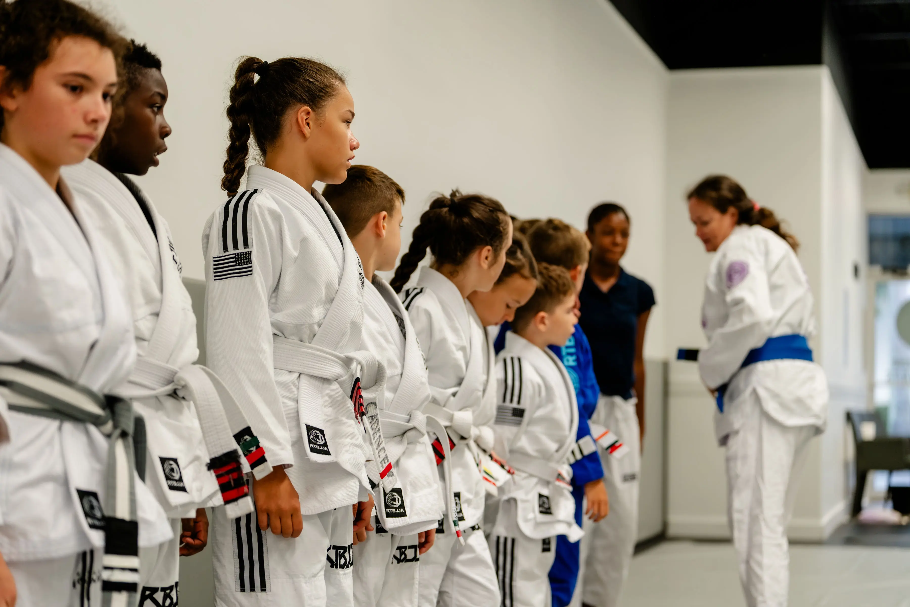Kids Jiu Jitsu class at RT Beachside: the class lined up in their Gis, listening